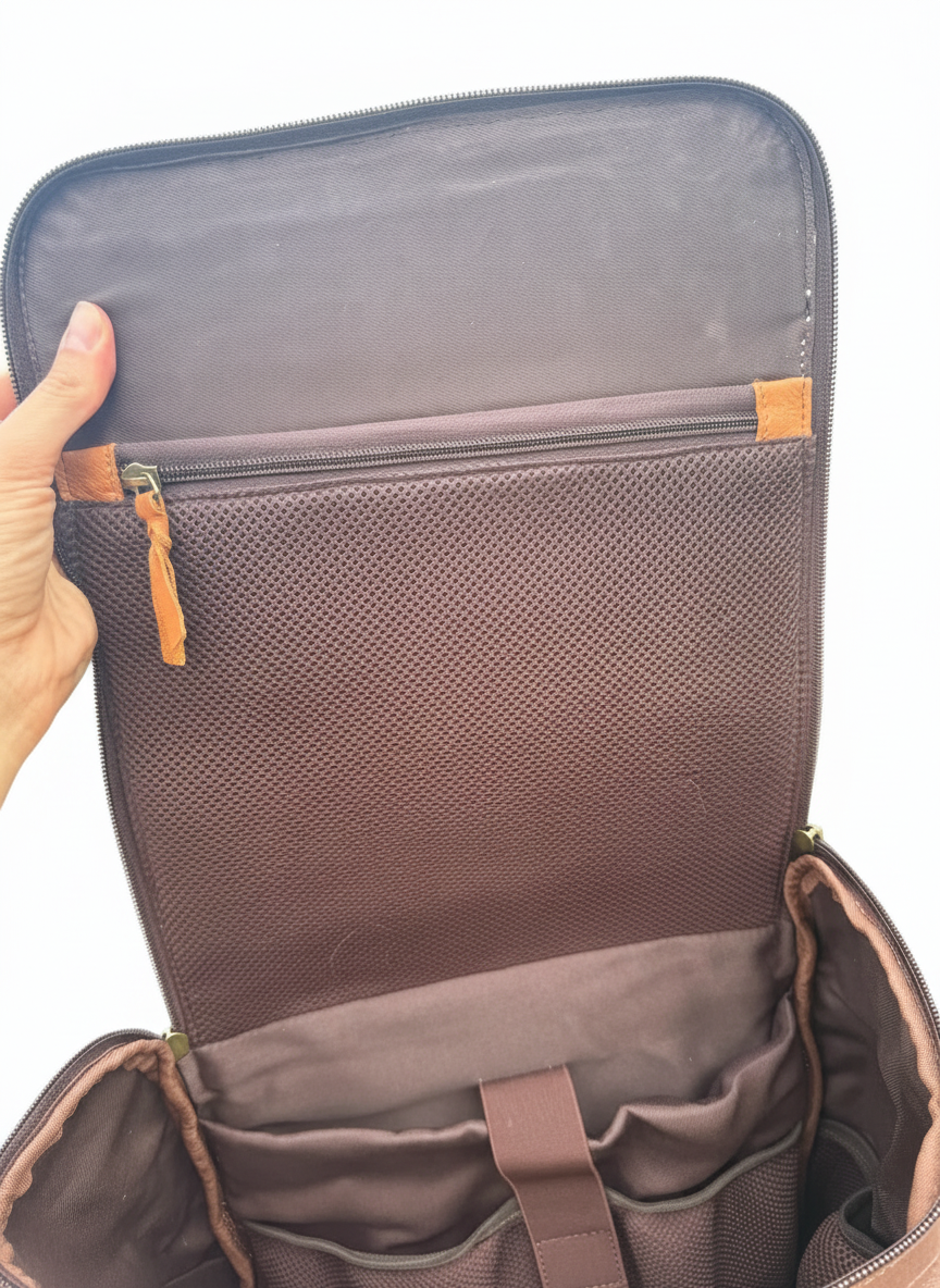 Brown leather briefcase held open with a scenic background